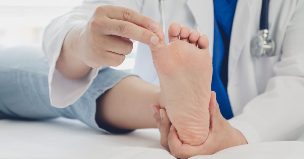 Doctor examining foot