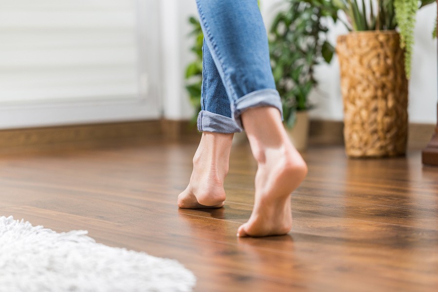 Young woman walking in the house on the warm floor after stem cell therapy.