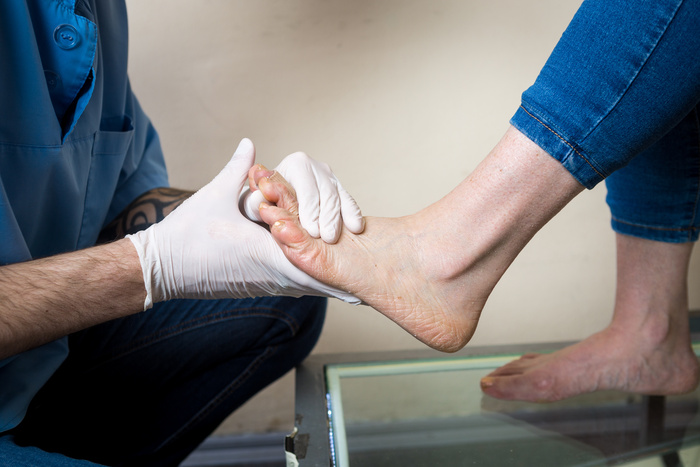 Podiatrist testing a foot for PAD